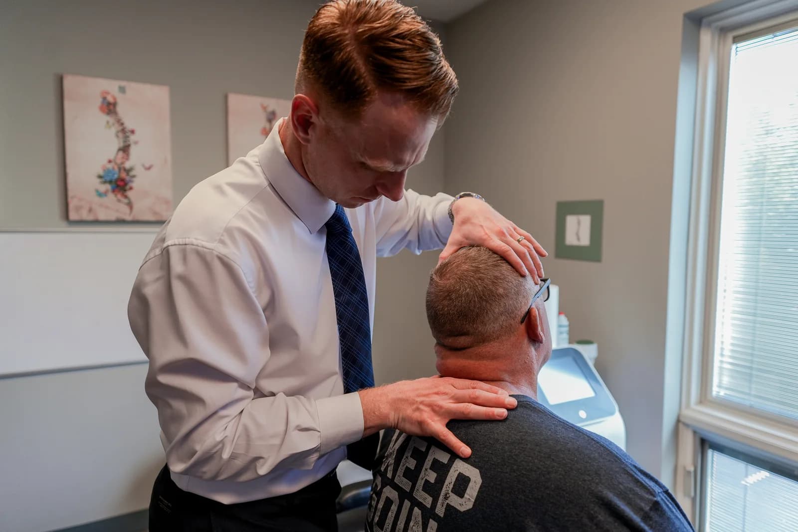 Dr. Ryan Bielecki performing a seated neck pain examination at SpineCo in Downers Grove, IL