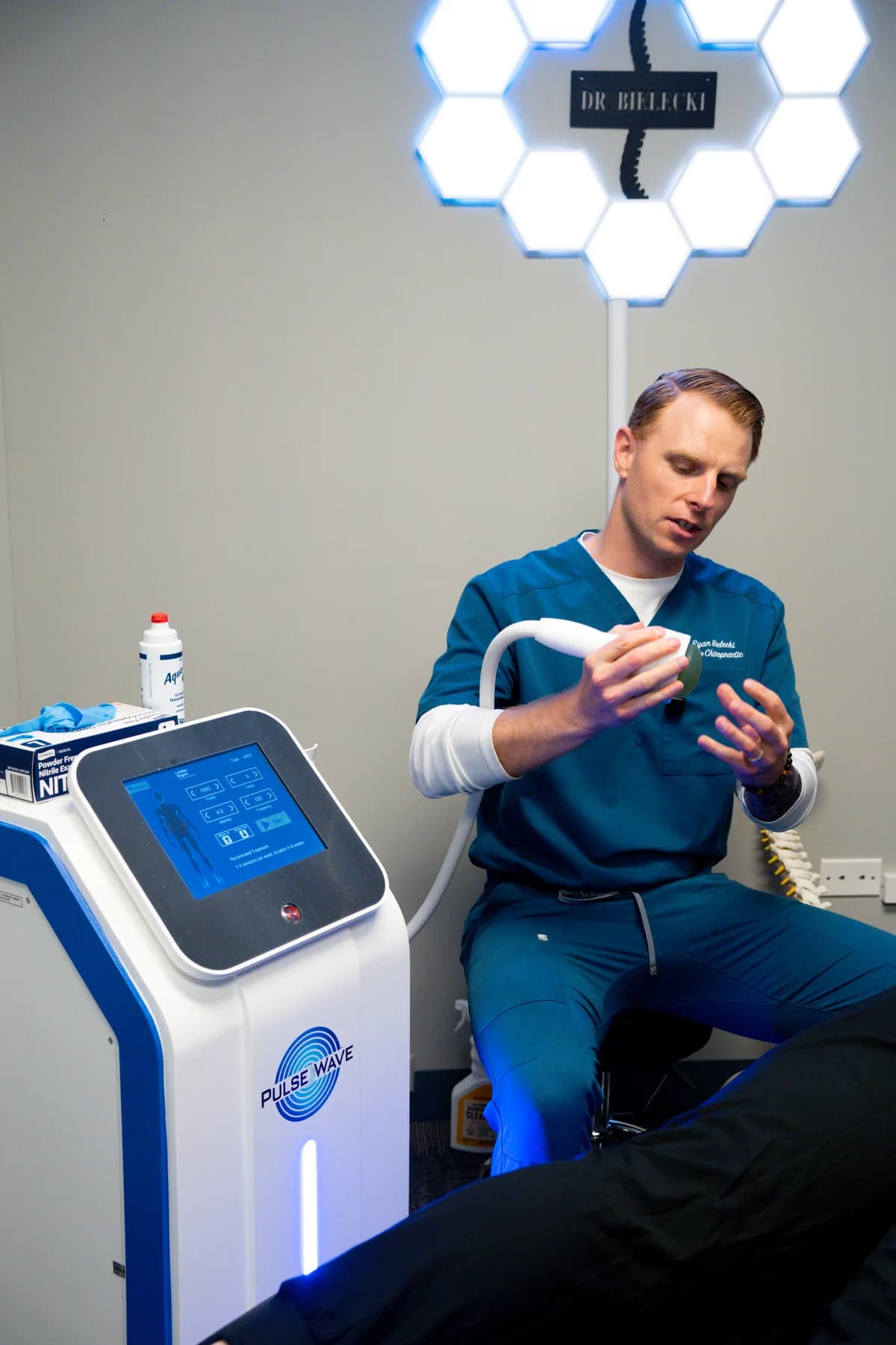 Dr. Ryan Bielecki explaining PulseWave therapy for extremity conditions at SpineCo in Downers Grove, IL